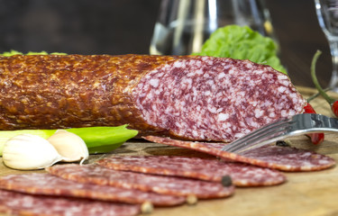 sausages on a wooden plate with vegetables in a restaurant