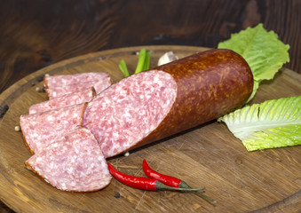 sausages on a wooden plate with vegetables in a restaurant