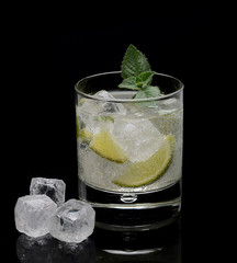 mojito with mint and ice on a black background