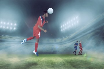 Naklejka premium Composite image of football player in red jumping