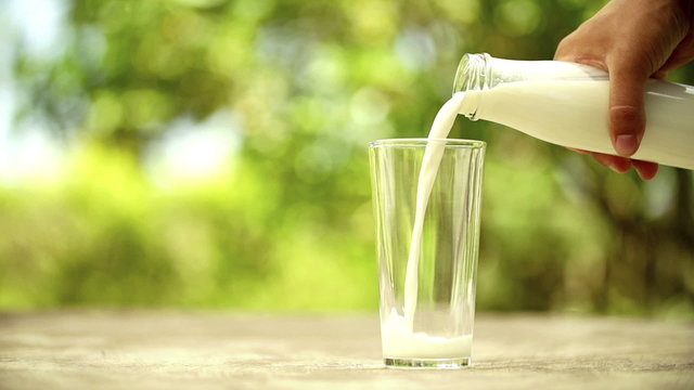 Pouring milk in glass in slow motion