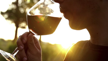 Man drinking red wine in slow motion - Powered by Adobe