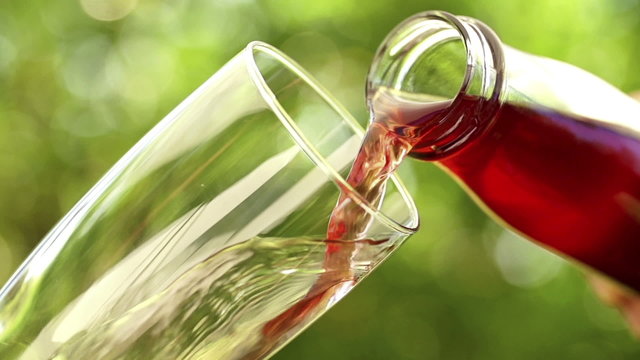 Pouring fresh juice into glass in slow motion