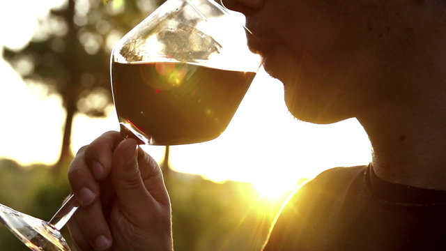 Man drinking red wine in slow motion