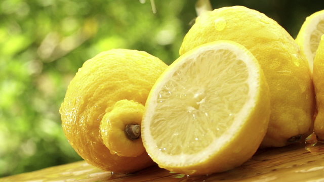 Water drops falling on lemons in slow motion