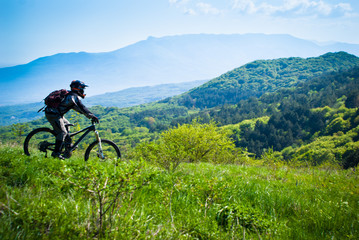 Fototapeta premium Dounhill rider in mountains