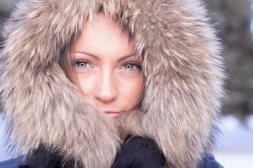 Beautiful girl in winter standing in the hood