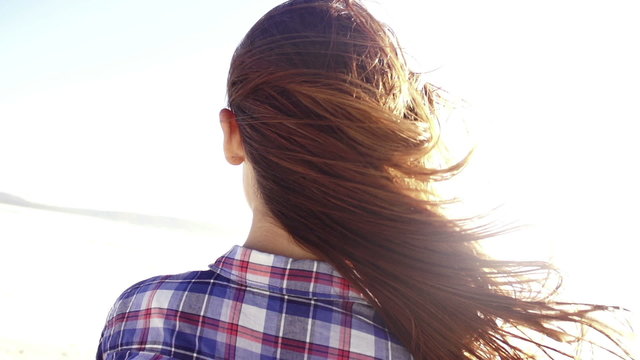 Girl at the beach wind in hair