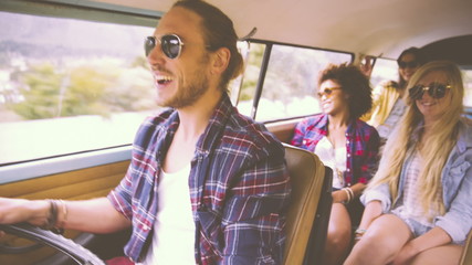 Driver talking to friends on road trip