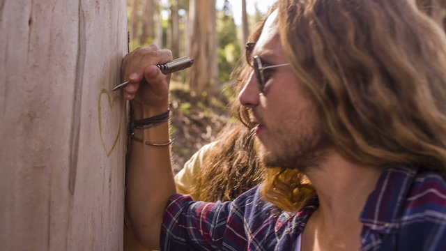 Couple is carving a heart