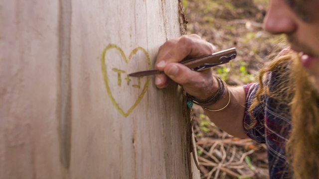 Couple is carving a heart