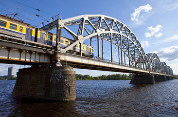 Train Crosses the Iron Bridge over the Daugava River in Riga