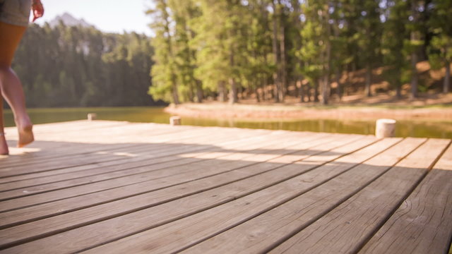 girl walking barefoot on jetty