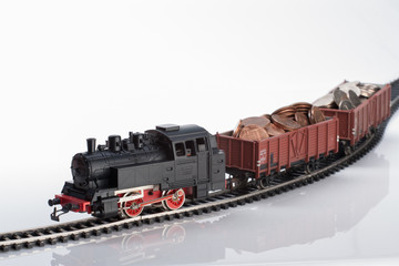 Fototapeta premium toy locomotive and coins
