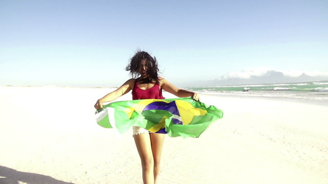 Cheerful girl from brazil with brazilian flag in slow motion