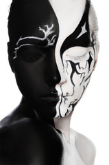 Portrait of woman with black and white face art