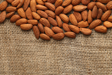 Almonds on sackcloth background