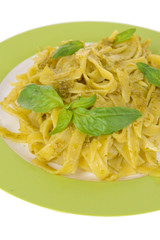 Delicious pasta with pesto on plate close-up