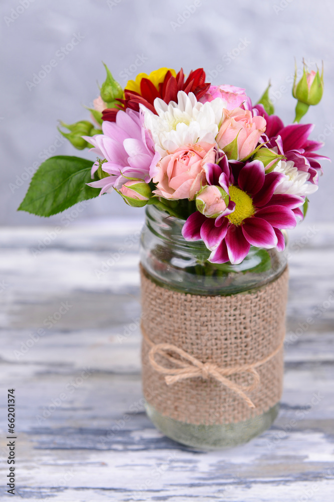 Wall mural Beautiful bouquet of bright flowers in jar