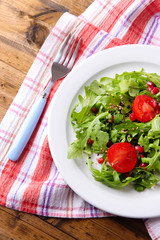 Green salad made with  arugula, tomatoes and sesame