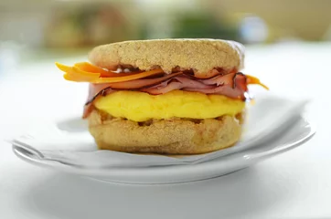 Tuinposter Egg, ham and cheese on whole wheat English muffin © fotogal