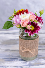 Beautiful bouquet of bright flowers in jar