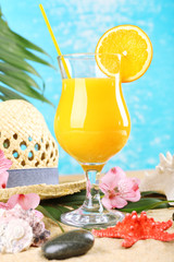 Refreshing orange cocktail on sand beach