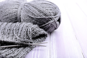 Knitting with spokes on wooden background