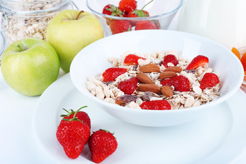 Healthy cereal with milk and fruits close up