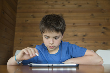 Naklejka premium Young boy and a tablet digital