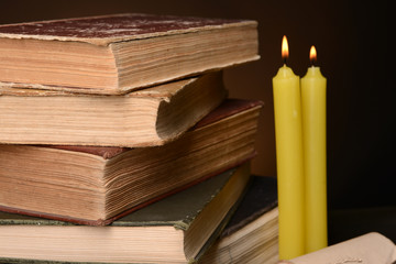 Old books on table on brown background