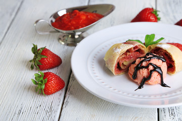 Tasty homemade strudel with ice-cream, fresh strawberry and