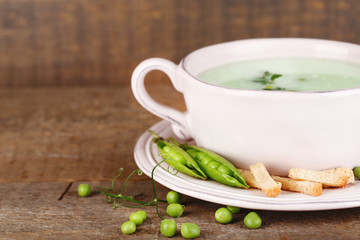 Tasty peas soup on wooden table
