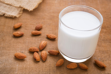 Almond milk and almond on wooden table