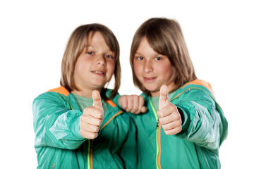 two twin brothers showing thumbs up