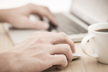 Hands of a man working with laptop