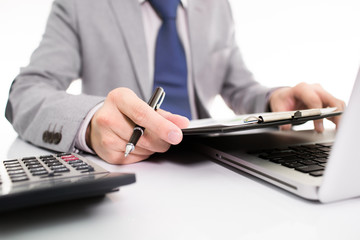 Fototapeta premium Businessman analyzing investment charts with laptop
