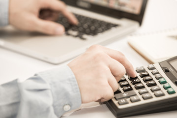 Businessman analyzing investment charts with laptop