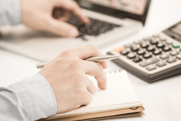 Businessman analyzing investment charts with laptop