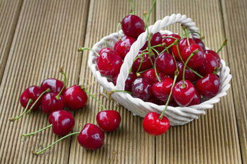 Ripe cherries on a wooden background