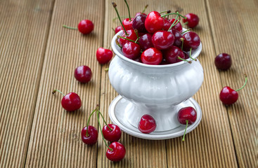 Ripe cherries on a wooden background
