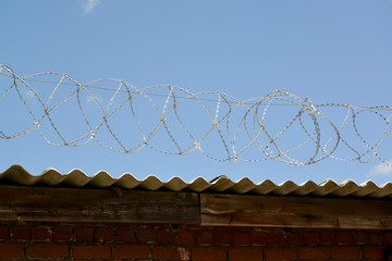Barbed wire against the blue sky