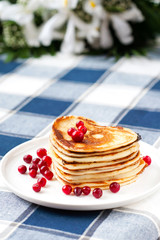 Heart shaped pancakes with cranberries. Morning surprise