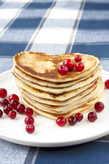 Celebration breakfast. Heart shaped pancakes with cranberries.