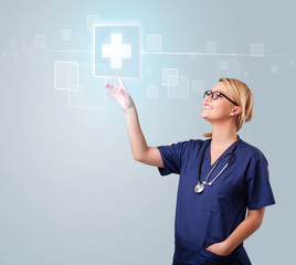 Young nurse pressing modern medical type of buttons