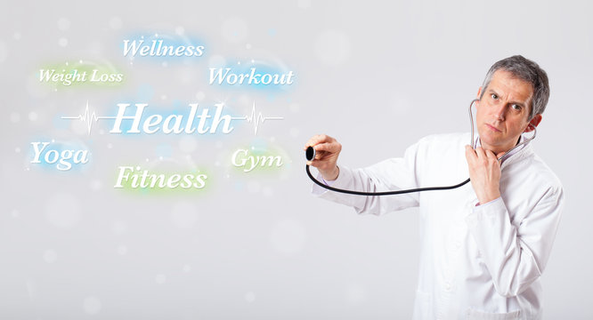 Clinical doctor pointing to health and fitness collection of wor