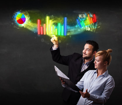 Young business couple touching colorful modern graph system conc