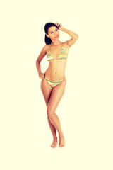 Obraz premium Full portrait of dark skined girl in bikini