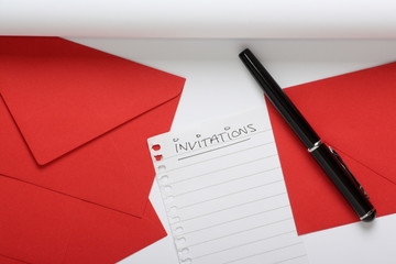 Invitations list with writing paper, pen and red envelopes