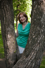 beautiful woman at a tree in summer